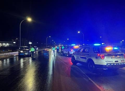 A BC Highway Patrol impaired driving check stop in slushy conditions at night in Prince George, BC