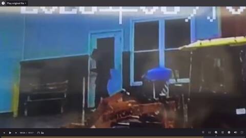 Surveillance image of an unidentified suspect in dark, baggy clothing at Cabot Car Wash in Lewisporte