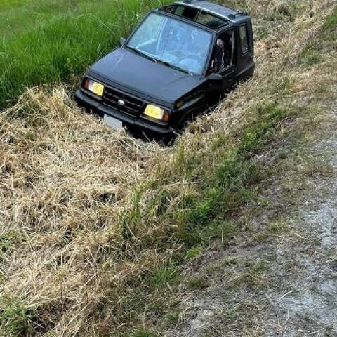 Photo of black Geo Tracker in ditch