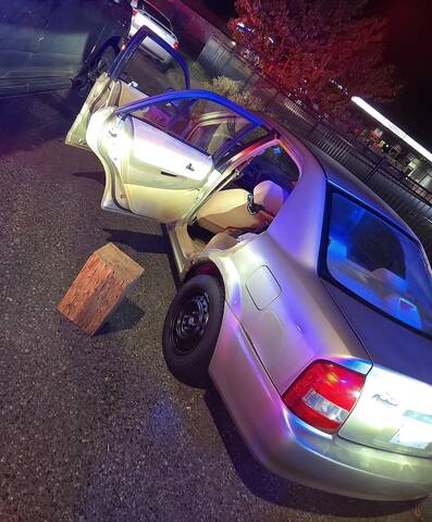 Photo of car boxed-in by an unmarked police vehicle.