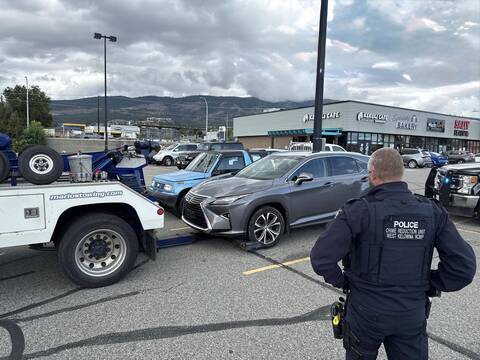 Officer standing with seized vehicle