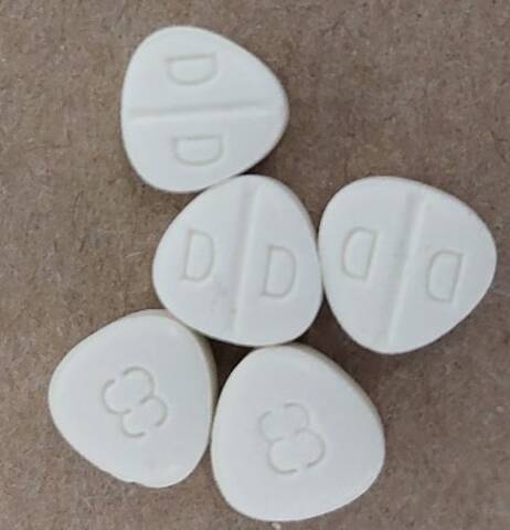 A picture of drugs in a white coloured pill form.