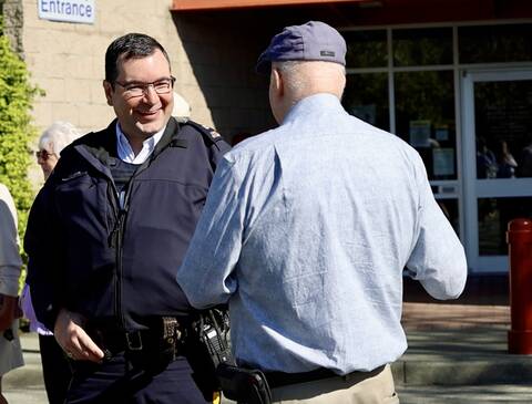 Inspector Stephen Rose, Acting Officer in Charge of West Shore RCMP speaks to a community member.