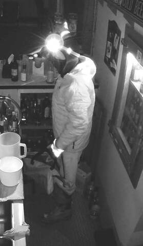 Male wearing an Under Armour hoodie, dark pants, winter boots, reflective rawhide gloves, and a headlamp. // Un homme portant un sweat à capuche Under Armour, un pantalon foncé, des bottes d'hiver, des gants en cuir brut réfléchissants et une lampe frontale.