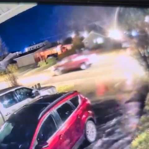 Photo of the red suspect truck on the street, taken from video surveillance