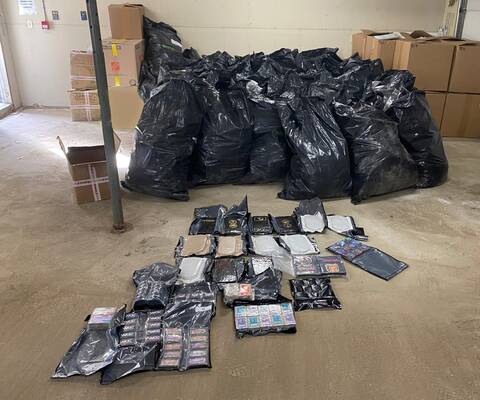 Seized boxes and bags of cannabis and bars of hashish