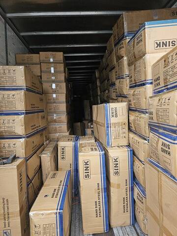 Photo of packaged sinks inside a trailer