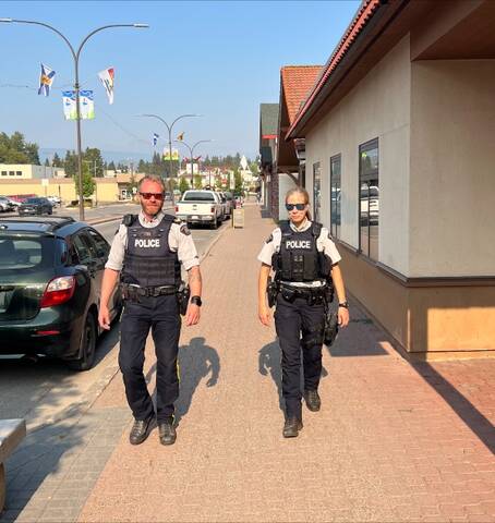 A/S/Sgt. Ryan Law and A/Cpl. Melissa Murray patrolling a street
