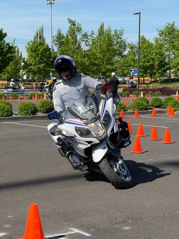 A BC Highway Patrol officer demonstrates a motorcycle skills course