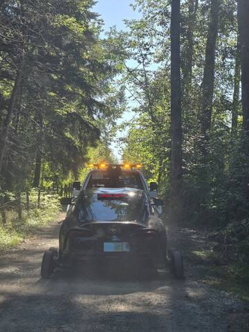 Black two door coupe being towed