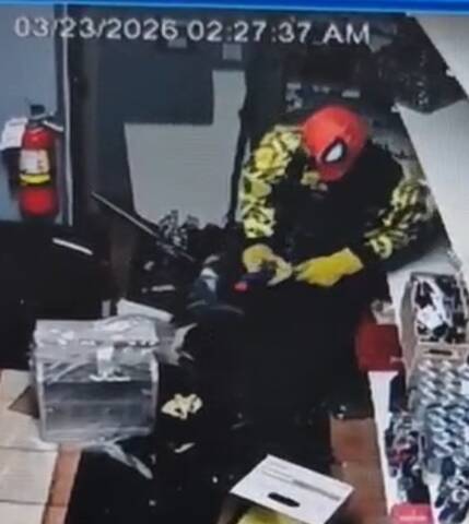 Surveillance image of suspect in yellow jacket and red Spider-Man mask involved in Leduc cigar business break and enter