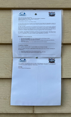 Order for immediate action posted on side of house
