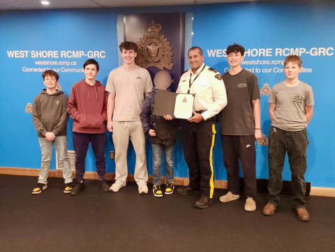 Youth group being presented with Appreciation Certificate by Inspector Saran.