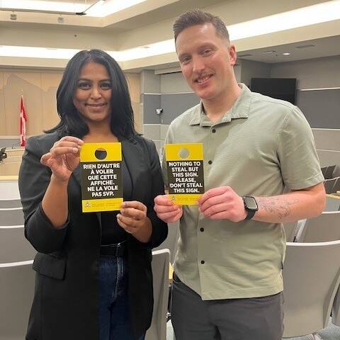 Volunteers with Chilliwack RCMP presenting the auto-crime alert notices.