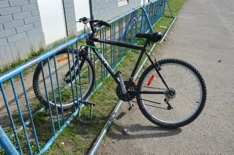 a bicycle locked to a stand