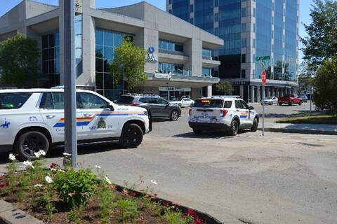Photo of RCMP vehicles driving in downtown Prince George.