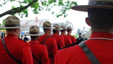 RCMP members lined up wearing serge