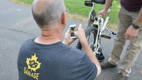 Photo of a Project 529 worker helping someone register their bike.