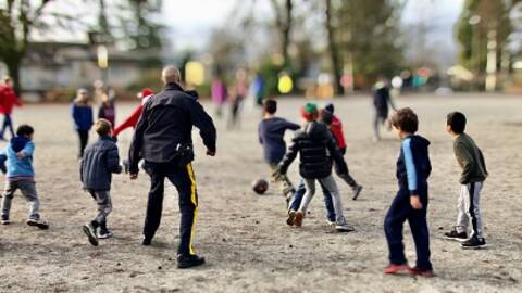 RCMP member playing soccer with kids