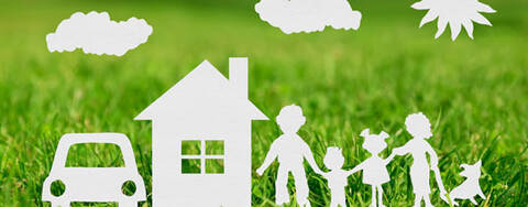 Paper cut out of family, house and grass