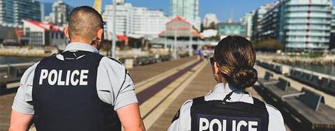 Two RCMP members walking on a oceanside dock