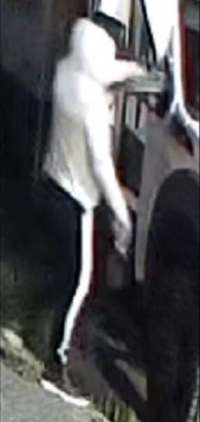 Rear view of suspect in light hoody and dark pants with stripe